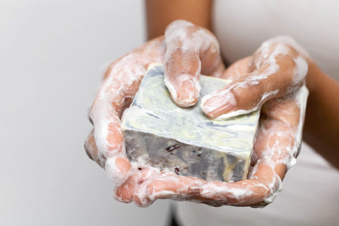 Person holding a lathered soap